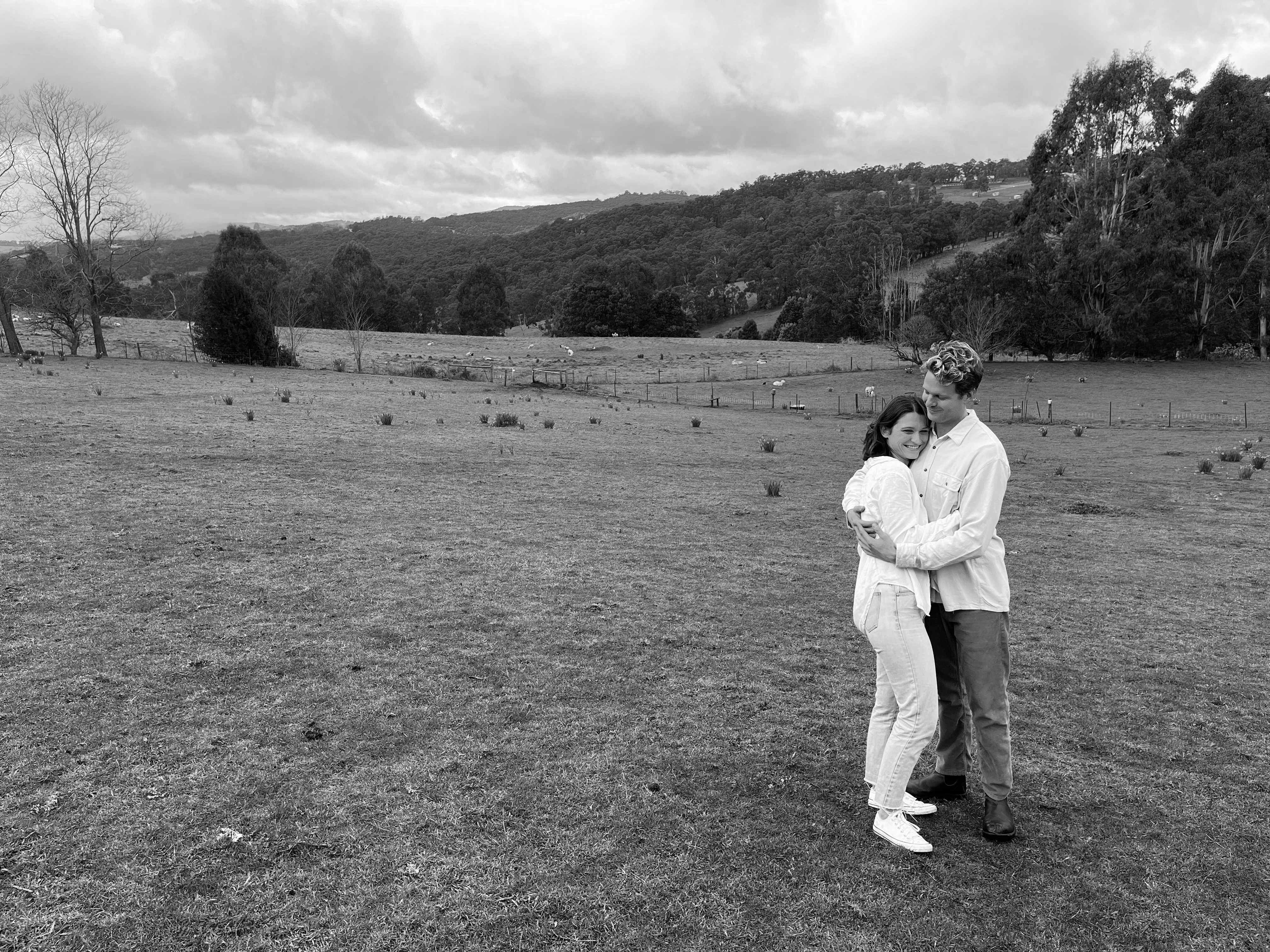 couple holding in a field